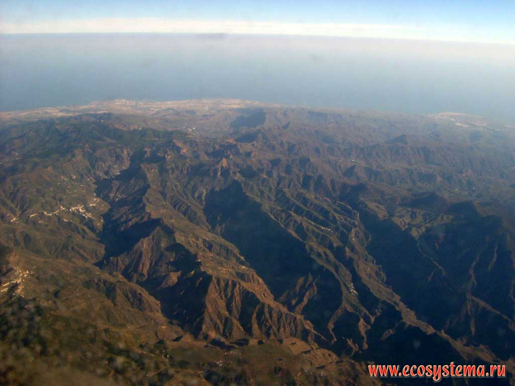 Volcanic massif Pico de las Nieves (Pozo de las Nieves) with the highest point of the island of Gran Canaria.
View from the aircraft (10 kilometers). Canary Archipelago