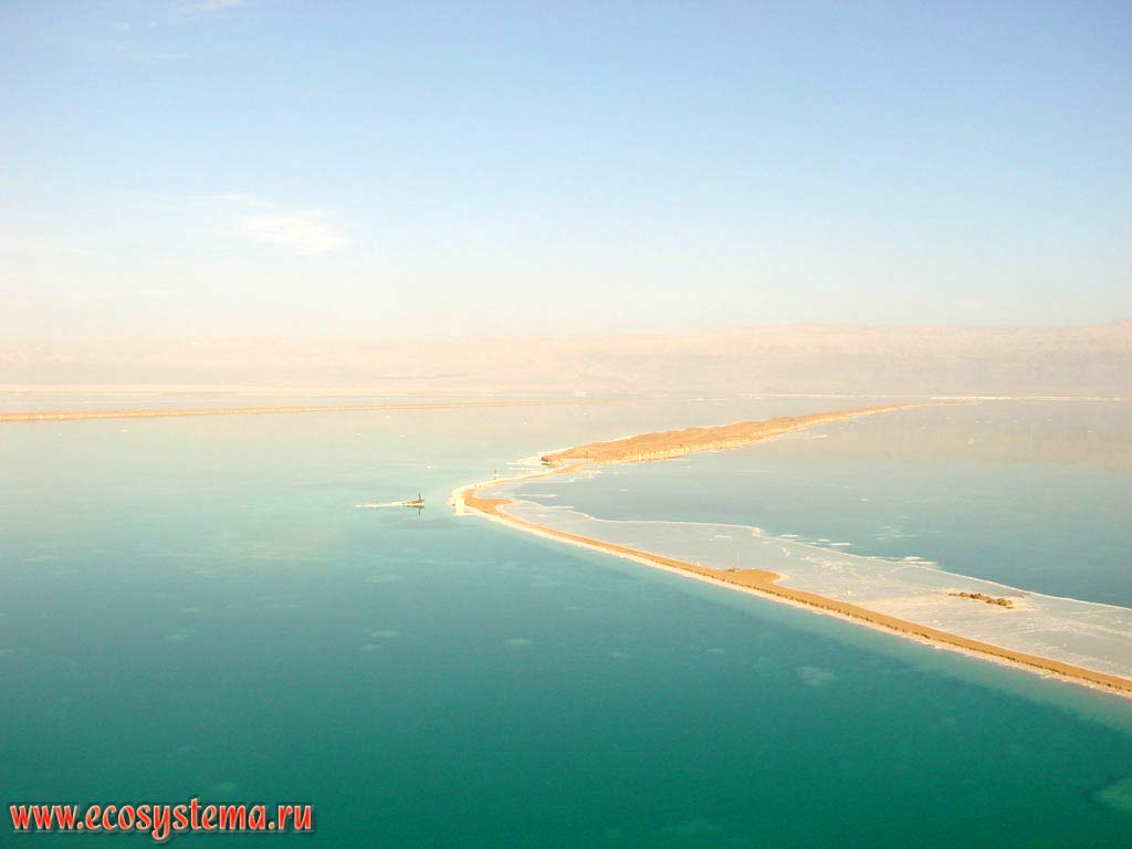 Sandy spit (sandbar) in the Dead Sea. The haze over the sea is a bromine reek (vapour). Asian Mediterranean (Levant), Dead Sea area, Israel