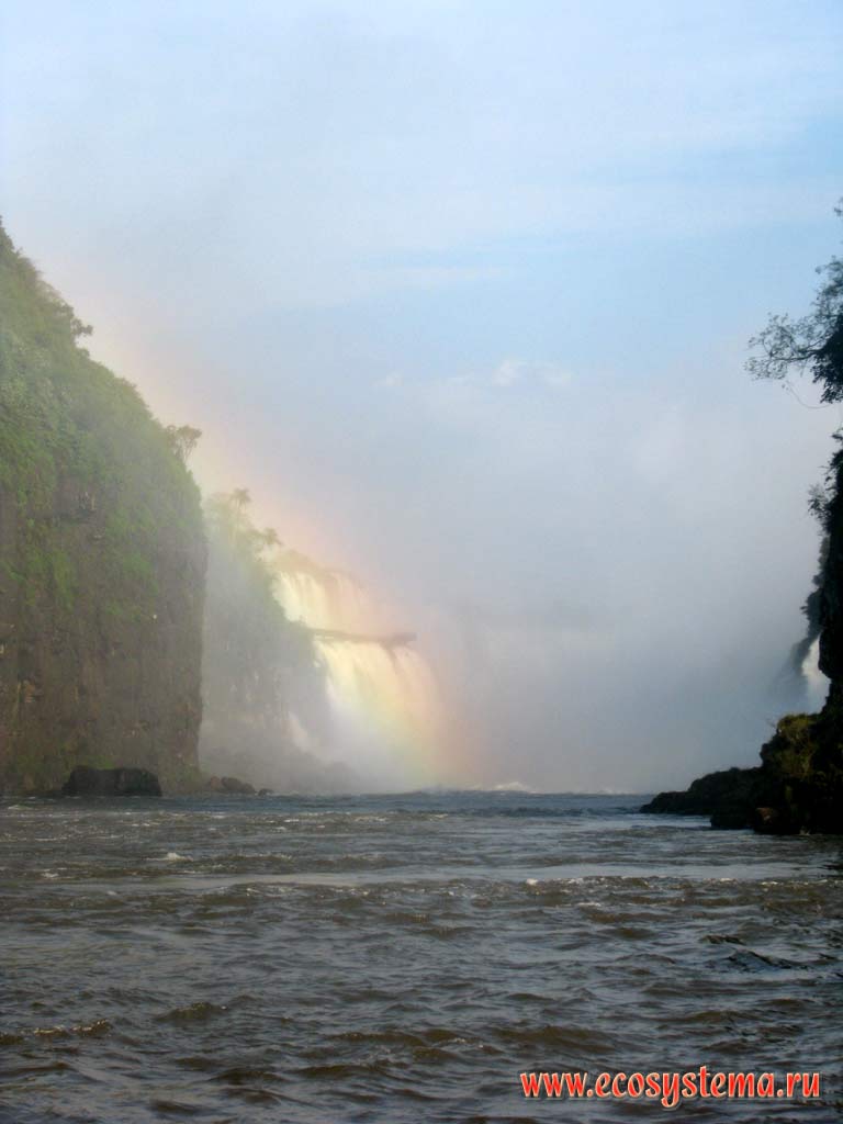 The rainbow over Iguazu river below the Iguazu Falls. Misiones province, Argentina