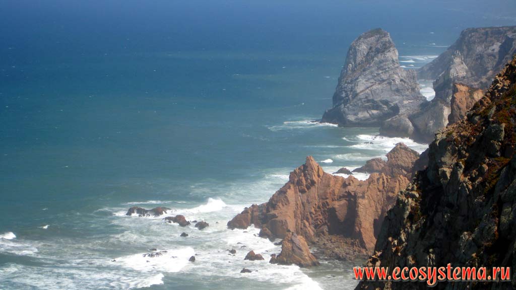 Escarpment cliffs on the Atlantic Ocean in the surf near Cape Roco (Cabo da Roca) - the extreme western point of Eurasia mainland. National Park of Sintra-Cascais on the west coast of Portugal