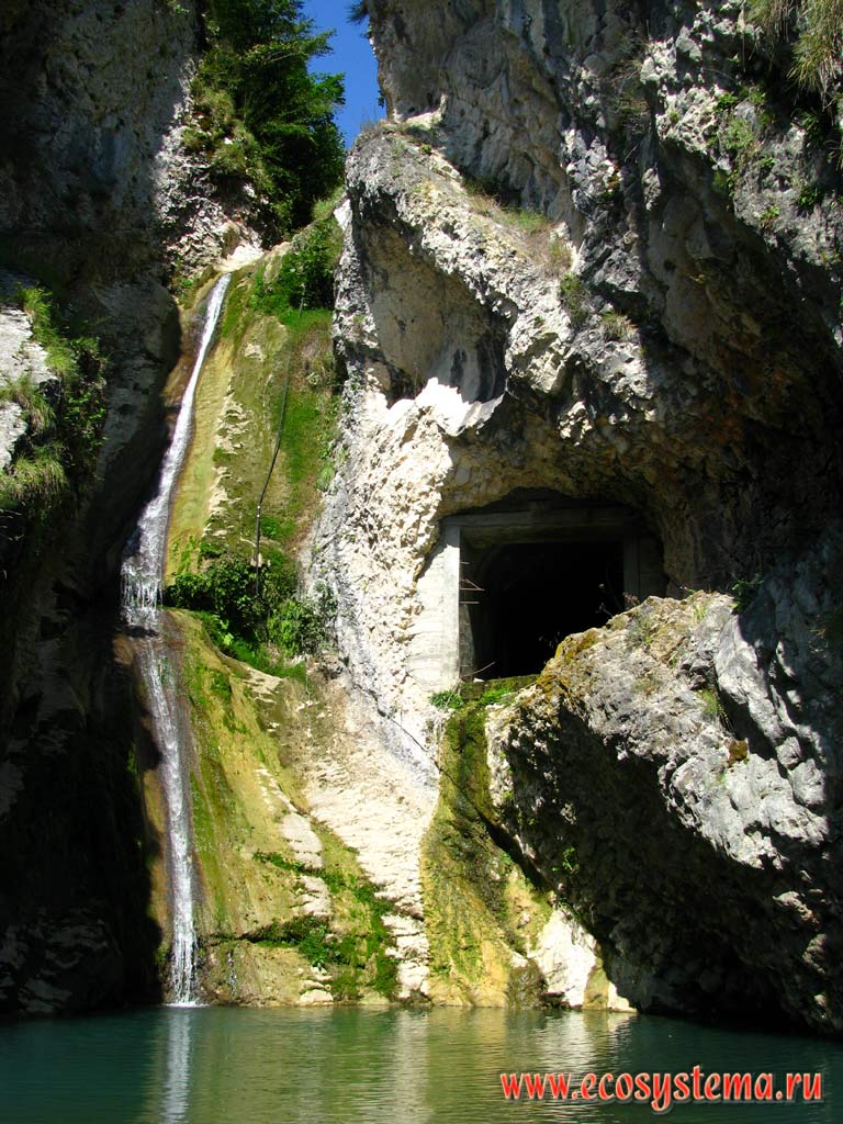 Небольшой водопад в горах и рядом выход шахты. Западный Кавказ, республика Абхазия