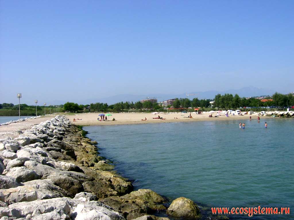 The artificial mound of stones - dam, breakwater, pier, which protects the bay from the destructive action of waves. The resort of Pescara in Abruzzo Region, Central Italy