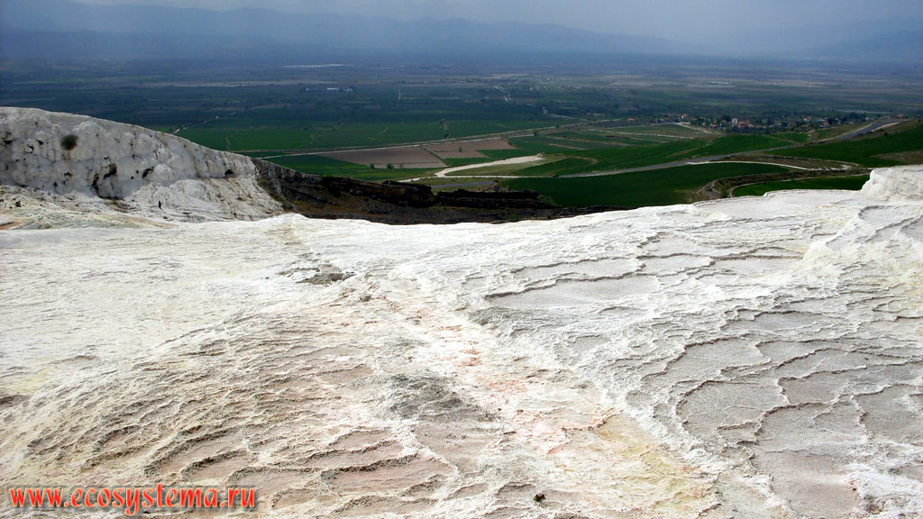 Terraces and baths of travertine – a sedimentary limestone rock formed from calcium carbonates, precipitated from carbonate hot spring waters, with the Menderes, or Meander River valley in the background