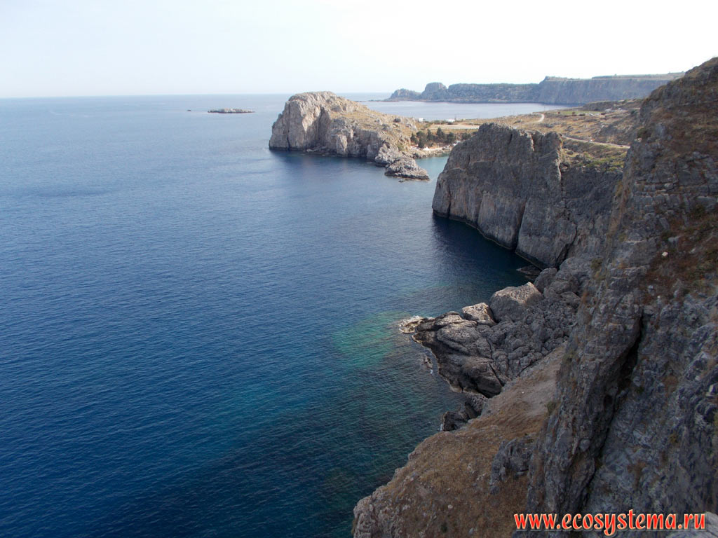 Cliffs on the coast of the island of Rhodes with medium-height mountains, composed of limestone, and bays of the Mediterranean Sea