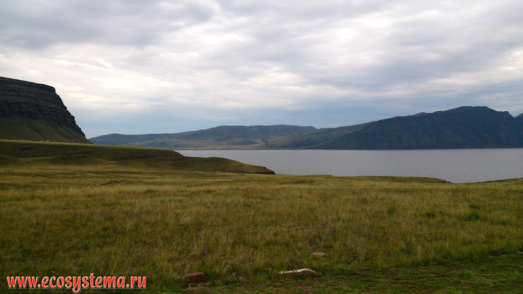 The valley of the Yenisei river and the Oglakhty mountain range with typical cuesta relief, as well as meadow steppe on the bank of the Krasnoyarsk reservoir on the Yenisei river in the Minusinsk intermountain basin
