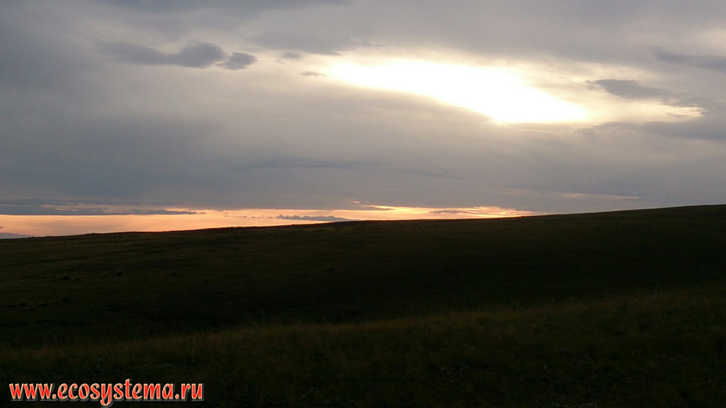 Sunset on the slopes of the Oglakhty mountain range near the Krasnoyarsk reservoir in the Minusinsk intermountain depression (basin)