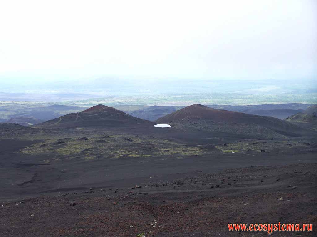 Шлаковые поля вокруг вулкана Толбачик, образованные при извержении
1975-76 гг. (БТТИ). Вдали - два конуса прорыва у подножия вулкана