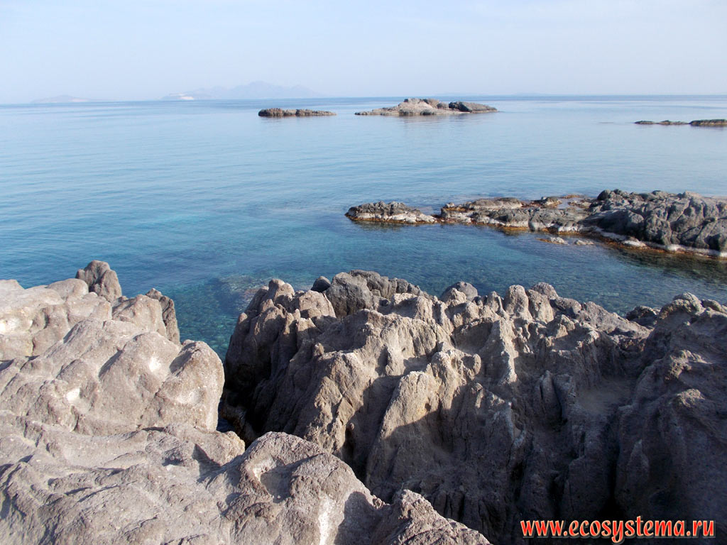 Abrasive coast and small coastal islands in the Bay of Kefalos (near the island of Kastri) and the Islands of Giali and Nisyros in the Aegean Sea (far away) on the South-West coast of the island of Kos
