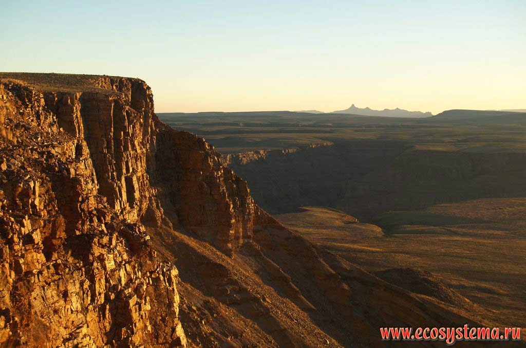 Стенка каньона Фиш-ривер (Fish River Canyon) на закате.
Трансграничный национальный парк Аи-Аис (Намибия) - Рихтерсвельд (ЮАР) (Ai-Ais / Richterveld Transfrontier National Park),
Южно-Африканское плоскогорье, южная Африка