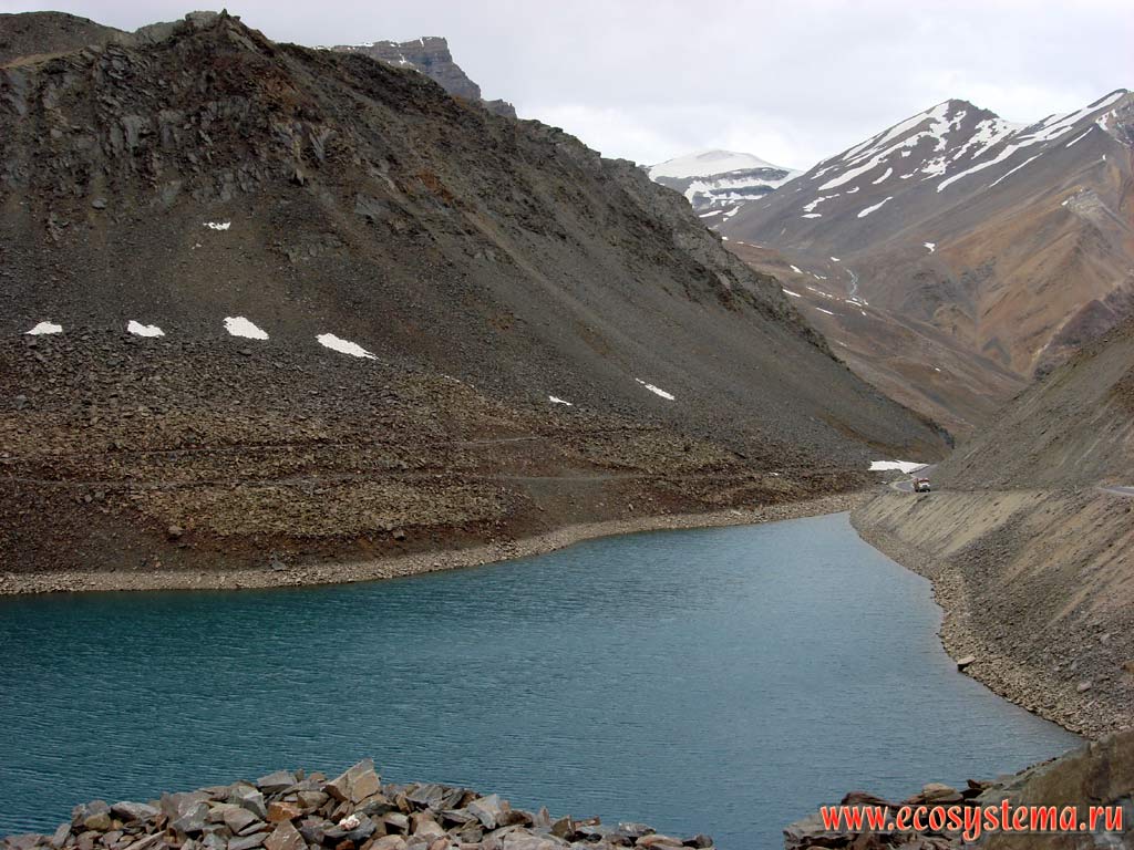 Highland (alpine) Lake Depak-Tal in the valley of glacier type (stream, dammed with the moraine) with signs of active denudation of the surrounding rocks. Height is about 4700 m above sea level. Great Himalayas, Himachal Pradesh, Northern India